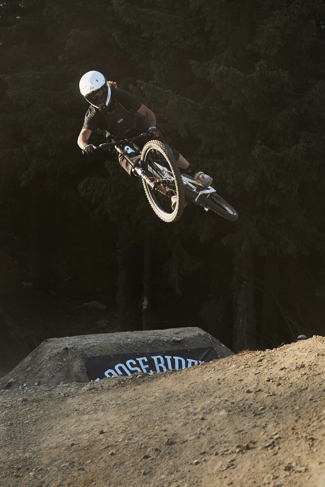 Rider whipping over a jump at a bike park