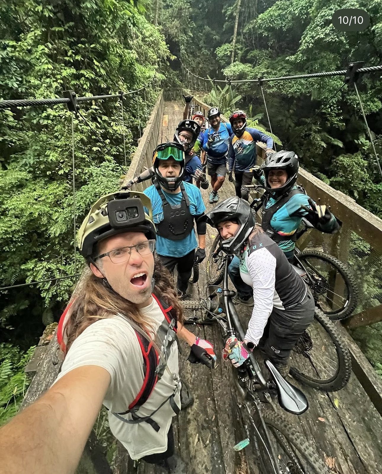 Ryan Rodriguez with a mountain bike clinic group on a jungle bridge in Guatemala