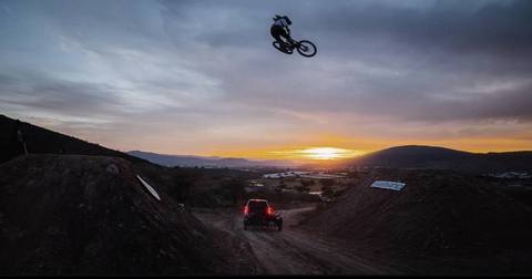 Mountain biker sending a jump at sunset