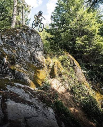 Ryan Rodriguez dropping off a mossy PNW rock face
